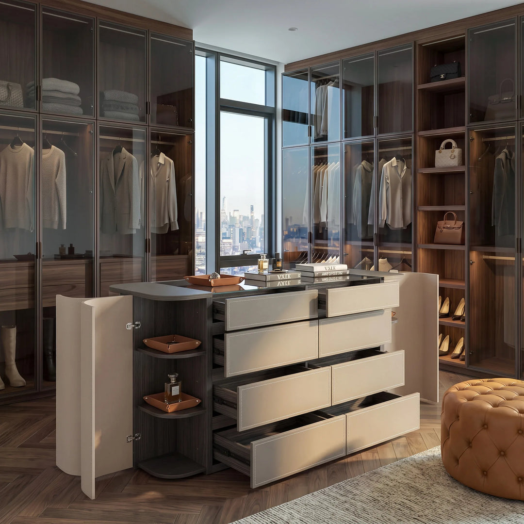 Upholstered closet island with open drawers in a walk-in closet