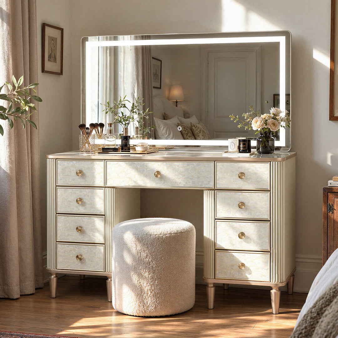 Freestanding makeup vanity with a lighted mirror and stool in a bright dressing area